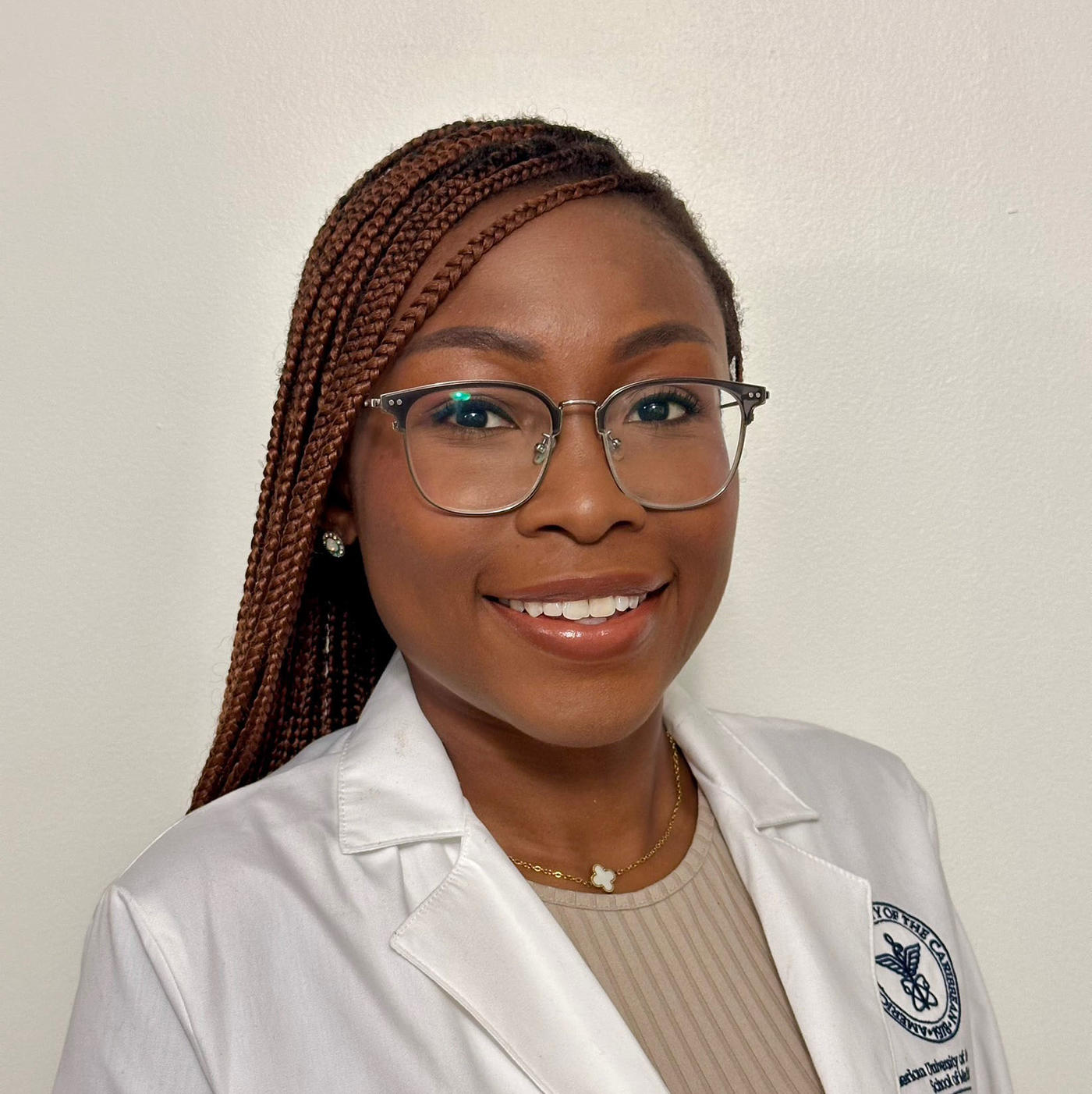 Lois Oladejo, AUC in white lab coat