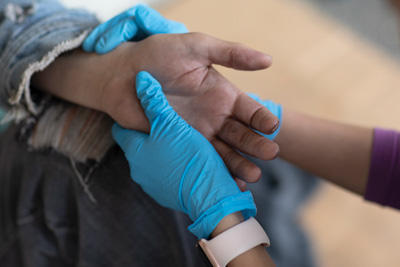 Chamberlain nurse's hands holding a patient's hand